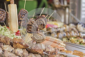 The concept of street food: grilled sausages on sticks