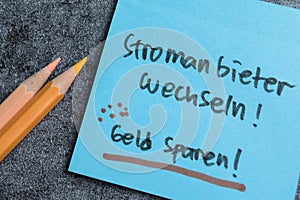 Concept of Stromanbieter Wechseln - Geld Sparen write on sticky notes isolated on Wooden Table photo