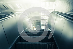 Concept of success in business, moving up the career path. Underground Escalator Conveor in Subway