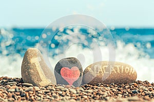 Concept of summer travel and sea holiday. Pebble beach and inscription I love vacation and drawn heart. Relax on tropical islands