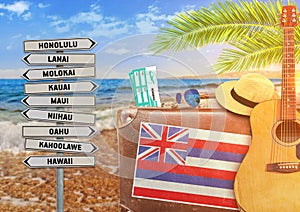 Concept of summer traveling with old suitcase and Hawaii town sign