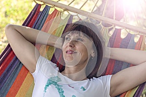 Concept summer, vacation, weekend- beautiful brunette girl lying on a hammock