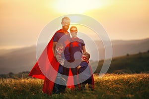 Concept of super family, family of superheroes at sunset