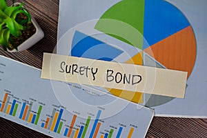 Concept of Surety Bond write on sticky notes isolated on Wooden Table