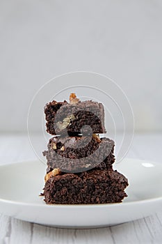 The concept of sweetness, useless food. Pyramid of three pieces of chocolate brownie