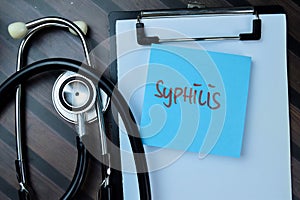 Concept of Syphilis write on sticky notes isolated on Wooden Table