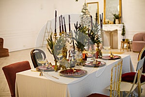The concept of table setting for the Christmas holidays. A beautiful and stylish decorated table is waiting for guests