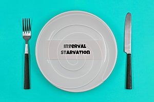 Concept, table setting, empty white plate with fork and knife on blue background, with one of the principles of healthy living - I