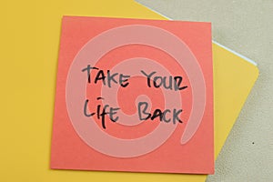 Concept of Take Your Life Back write on sticky notes isolated on Wooden Table