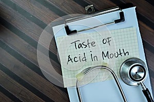 Concept of Taste Of Acid in Mouth write on sticky notes isolated on Wooden Table