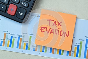 Concept of Tax Evasion write on book isolated on Wooden Table