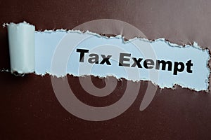 Concept of Tax Exempt Text written in torn paper photo