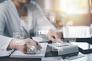 Concept tax payment optimisation business finance,woman using pen write note book with taxes icon on technology screen,income tax