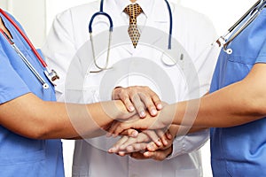 Concept Teamwork doctor and nurses coordinate hands