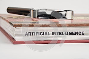 The concept of technology and development. Phrase, word, text ARTIFICIAL INTELLIGENCE on the end of the book, a close-up