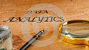 The concept of technology and development. Phrase, words, text DATA ANALYTICS text API written on paper, front view