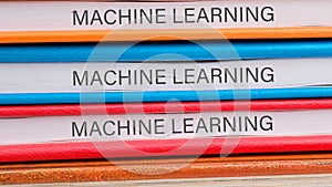 The concept of technology and development. Phrase, words, text MACHINE LEARNING close-up on the ends of the notebooks