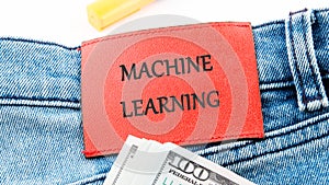The concept of technology and development. Phrase, words, text MACHINE LEARNING on the leather label of jeans