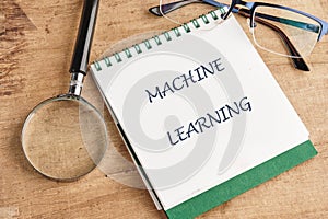 The concept of technology and development. Phrase, words, text MACHINE LEARNING in a notebook on an old background, in a