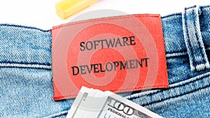 The concept of technology and development. Phrase, words, text SOFTWARE DEVELOPMENT on the leather label of jeans