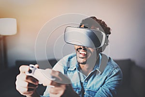 Concept of technology,gaming,entertainment and people.African man playing virtual reality glasses video game while photo