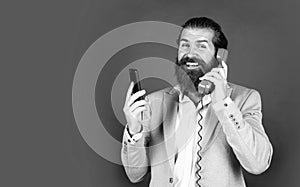 concept of technology progress. Then and Now. mature bearded man talk on retro phone. male hold smartphone. compare
