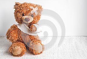 Concept teddy bear childhood diseases at textile background