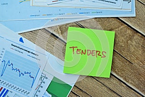 Concept of Tenders write on sticky notes isolated on Wooden Table