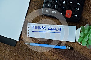 Concept of Term Loan write on sticky notes isolated on Wooden Table