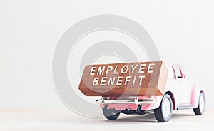 Concept is text employee benefits on the wood with car.