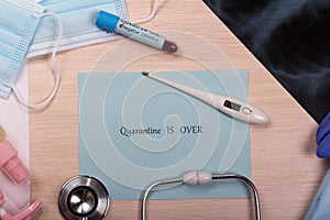 Concept thermometer with readings 36.6, test tube with a negative test for Covid-19, a stethoscope and the inscription quarantine