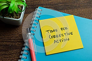 Concept of Time for Corrective Action write on sticky notes isolated on Wooden Table