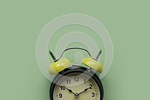 Concept of time, reminder, countdown, alert, deadline. Alarm clock isolated on green background.Copy space