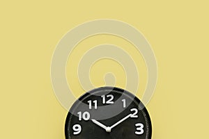 Concept of time, reminder, countdown, alert, deadline. Wall clock isolated on yellow background.Copy space