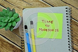 Concept of Time to Modernize write on sticky notes isolated on Wooden Table