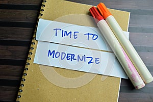 Concept of Time To Modernize write on sticky notes isolated on Wooden Table photo