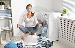 Concept. tired housewife meditates in lotus position in laundry