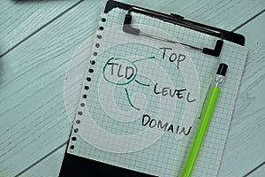 Concept of TLD - Top Level Domain write on paperwork isolated on Wooden Table