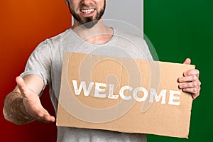 The concept of tolerance for immigrants and people of different life positions. A man holds a cardboard and stretches out his hand