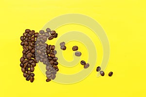 Concept tooth of coffee grains collapses under the influence of coffee