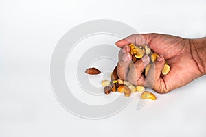 Concept, trail mix day. handful men trail mix on white background. closeup. copy space on left