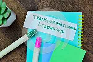 Concept of Transformational Leadership write on sticky notes isolated on Wooden Table photo
