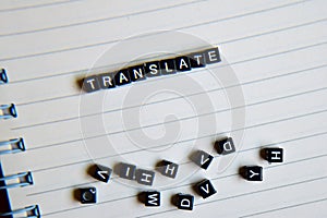 Concept of Translate word on wooden cubes with books in background