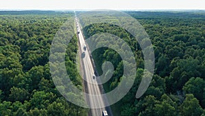 The concept of transport marketing. Several trucks with trailers on a busy highway. Organization of cargo transportation