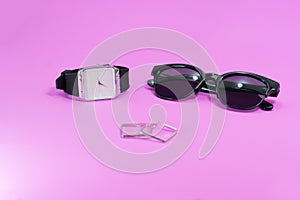 Concept travel on holiday. Sunglasses with black watch