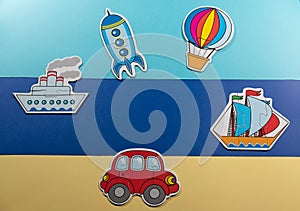 Concept of travel by land sea and air on a yellow-blue background of children`s toys