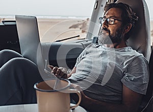 Concept of travel lifestyle modern people and smart working digital nomad job activity. Handsome man use laptop computer sitting