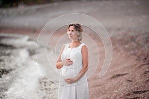 Concept of travel in pregnancy, healthy vacation. Portrait of middle aged pregnant woman. Purity