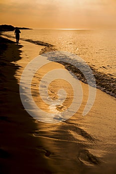 The concept of travel and rest at the seaside, sea waves on the background of the shoreline and sunset