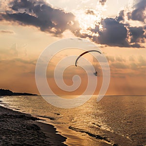 The concept of travel and rest at the seaside, sea waves on the background of the shoreline and sunset